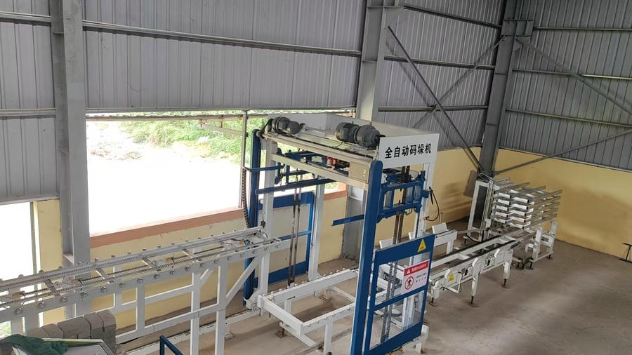 Finished two-hole concrete brick stacks outside Vietnam factory after Hawen automatic cubing solution