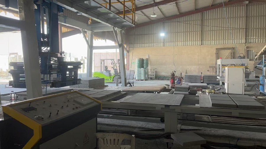 Cuber gripping and stacking concrete blocks during packaging